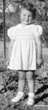 Lorraine Moll, about 3, fence behind